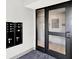 Interior mailbox area with directory, and adjacent glass door to the building's common area at 920 Veterans Way # 204, Carmel, IN 46032