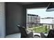 Cozy outdoor patio with wicker furniture overlooking a lawn and building at 920 Veterans Way # 204, Carmel, IN 46032