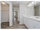 Bright bathroom with double sinks, wood-look flooring, and access to the bedroom and closet at 10420 Day Star Dr, Indianapolis, IN 46234