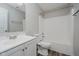 A full bathroom with a shower and tub, a white vanity, and wood-look flooring at 10420 Day Star Dr, Indianapolis, IN 46234