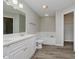 Well-lit bathroom featuring double sinks, tub, toilet, and wood-look flooring at 10420 Day Star Dr, Indianapolis, IN 46234