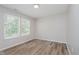 Bright, empty bedroom with wood floors and natural light streaming in through the windows at 10420 Day Star Dr, Indianapolis, IN 46234