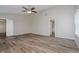 This bedroom features neutral paint, wood-look flooring, a ceiling fan, and a bathroom at 10420 Day Star Dr, Indianapolis, IN 46234