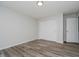 This bedroom features neutral paint, wood-look flooring, and a double closet at 10420 Day Star Dr, Indianapolis, IN 46234