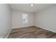 This bedroom features neutral paint and wood-look flooring at 10420 Day Star Dr, Indianapolis, IN 46234
