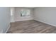 Bright bedroom with neutral walls, wood-look floors, and a large window for natural light at 10420 Day Star Dr, Indianapolis, IN 46234