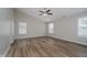 This bedroom features neutral paint, wood-look flooring, and lots of natural light at 10420 Day Star Dr, Indianapolis, IN 46234
