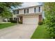 Well-maintained two-story home with a spacious driveway, two-car garage, and manicured landscaping at 10420 Day Star Dr, Indianapolis, IN 46234