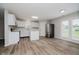 Modern kitchen with white cabinets, stainless steel appliances, island and wood-look floors at 10420 Day Star Dr, Indianapolis, IN 46234