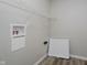 Bright laundry area features durable flooring, shelving, and convenient access to water hookups at 10420 Day Star Dr, Indianapolis, IN 46234