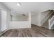 Open-concept living area with wood floors, a ceiling fan, and access to a staircase at 10420 Day Star Dr, Indianapolis, IN 46234