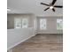 Spacious living area with wood-style floors and access to a patio at 10420 Day Star Dr, Indianapolis, IN 46234