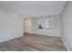 Spacious living room with wood-look floors, large windows, and neutral paint at 10420 Day Star Dr, Indianapolis, IN 46234