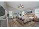 Spacious main bedroom featuring a ceiling fan, wood-look flooring, and a seating area at 10420 Day Star Dr, Indianapolis, IN 46234