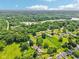A scenic aerial view of a suburban neighborhood features lush trees and a tranquil lake at 10444 Indian Lake N Blvd, Indianapolis, IN 46236