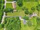 Aerial view of the property showing the home's location, surrounded by trees and lush greenery at 10444 Indian Lake N Blvd, Indianapolis, IN 46236