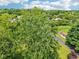 An aerial shot offers a tree-filled view of the neighborhood at 10444 Indian Lake N Blvd, Indianapolis, IN 46236