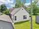 The back exterior reveals a well-kept lawn, storage shed, wooden deck, and classic siding at 10444 Indian Lake N Blvd, Indianapolis, IN 46236