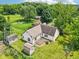 Property showing a spacious lawn, a wooden deck, a storage shed, and beautiful landscaping at 10444 Indian Lake N Blvd, Indianapolis, IN 46236