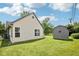 Backyard exterior featuring lush lawn and shed at 10444 Indian Lake N Blvd, Indianapolis, IN 46236