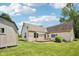 A spacious backyard with a wooden deck, lush green lawn, and a shed provides outdoor living and storage at 10444 Indian Lake N Blvd, Indianapolis, IN 46236