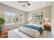 Serene bedroom with a ceiling fan, large window, and comfortable bed with decorative pillows at 10444 Indian Lake N Blvd, Indianapolis, IN 46236