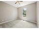 Carpeted bedroom with neutral walls, ceiling fan, and a single window providing natural light at 10444 Indian Lake N Blvd, Indianapolis, IN 46236