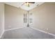 Empty carpeted bedroom with ceiling fan, and a window providing natural light at 10444 Indian Lake N Blvd, Indianapolis, IN 46236