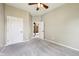 A bright, carpeted bedroom with neutral walls and a white door at 10444 Indian Lake N Blvd, Indianapolis, IN 46236