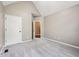 Empty carpeted bedroom with neutral walls and a white door at 10444 Indian Lake N Blvd, Indianapolis, IN 46236