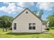 Exterior view of a home with light yellow siding, white trim, and green grass surrounding the perimeter at 10444 Indian Lake N Blvd, Indianapolis, IN 46236