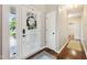 Bright and inviting foyer featuring hardwood floors and a decorative glass door and wreath at 10444 Indian Lake N Blvd, Indianapolis, IN 46236