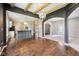 Open concept kitchen with hardwood floors, island with breakfast bar, and decorative lighting flowing into the living room at 10444 Indian Lake N Blvd, Indianapolis, IN 46236