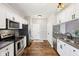 Kitchen area with stainless steel appliances, granite countertops, mosaic backsplash, and hardwood floors at 10444 Indian Lake N Blvd, Indianapolis, IN 46236