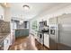 Bright kitchen with stainless steel appliances, granite countertops, mosaic backsplash, and hardwood floors at 10444 Indian Lake N Blvd, Indianapolis, IN 46236
