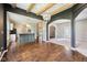Open-concept living space with wood beams, chandelier, and modern kitchen island at 10444 Indian Lake N Blvd, Indianapolis, IN 46236