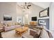Bright living room features a fireplace, ceiling fan, and a neutral color palette at 10444 Indian Lake N Blvd, Indianapolis, IN 46236
