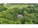 Gorgeous aerial perspective of a home tucked away in a dense forest, providing unparalleled privacy and natural surroundings at 10808 Greenbriar Dr, Fishers, IN 46037