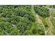 Aerial view of a home surrounded by lush greenery and bordering a verdant golf course at 10808 Greenbriar Dr, Fishers, IN 46037
