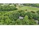 Breathtaking aerial view of a home hidden among vibrant green trees, providing ultimate privacy and a serene retreat by a golf course at 10808 Greenbriar Dr, Fishers, IN 46037