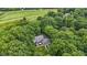 Stunning aerial view of a home nestled among a forest, near an adjacent golf course, and surrounded by natural beauty at 10808 Greenbriar Dr, Fishers, IN 46037