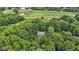 Scenic aerial shot of home enveloped by vibrant green trees, offering an exclusive and nature-rich environment close to a golf course at 10808 Greenbriar Dr, Fishers, IN 46037