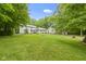Extensive backyard with lush lawn, mature trees, and well-maintained greenery offers privacy at 10808 Greenbriar Dr, Fishers, IN 46037