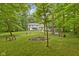 Secluded backyard with fire pit, mature trees, and lush green space offers outdoor enjoyment at 10808 Greenbriar Dr, Fishers, IN 46037