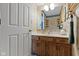 Bathroom with decorative wallpaper, vanity and large wall mirror at 10808 Greenbriar Dr, Fishers, IN 46037