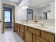 Bathroom with tile floor, a double sink vanity, and a large wall mirror at 10808 Greenbriar Dr, Fishers, IN 46037