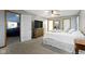 Large bedroom with ceiling fan, attached bathroom, and comfortable neutral carpeting at 10808 Greenbriar Dr, Fishers, IN 46037
