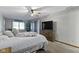 Inviting bedroom with a ceiling fan, large window, and comfortable bed at 10808 Greenbriar Dr, Fishers, IN 46037