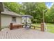 Inviting wooden deck featuring a hot tub, seating area with umbrella, and tranquil backyard views at 10808 Greenbriar Dr, Fishers, IN 46037