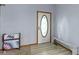 Inviting entryway featuring a white door with an oval window, and light wood-look floors at 10808 Greenbriar Dr, Fishers, IN 46037
